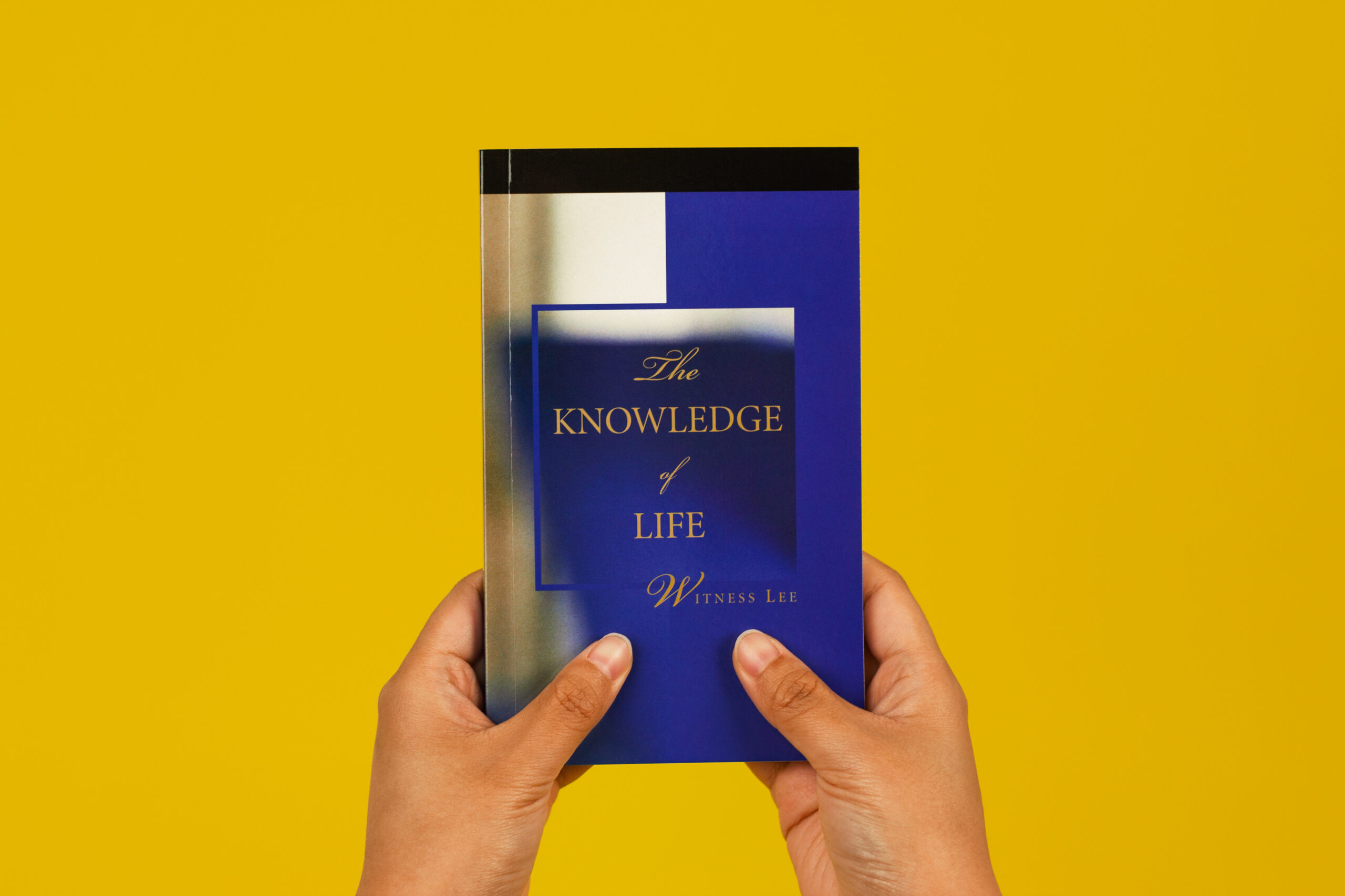 Person holding Knowledge of Life book